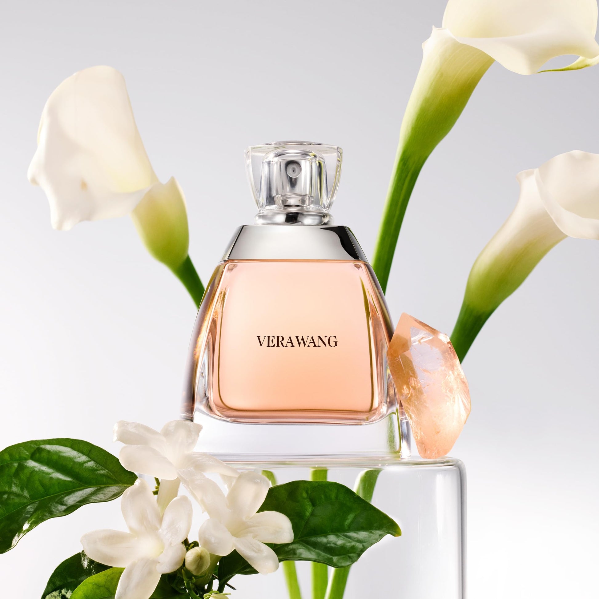 Vera Wang perfume bottle with flowers on a reflective surface