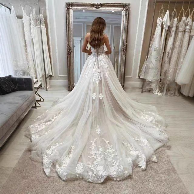 Elegant strapless bridal gown with fitted lace bodice and flowing polyester skirt

