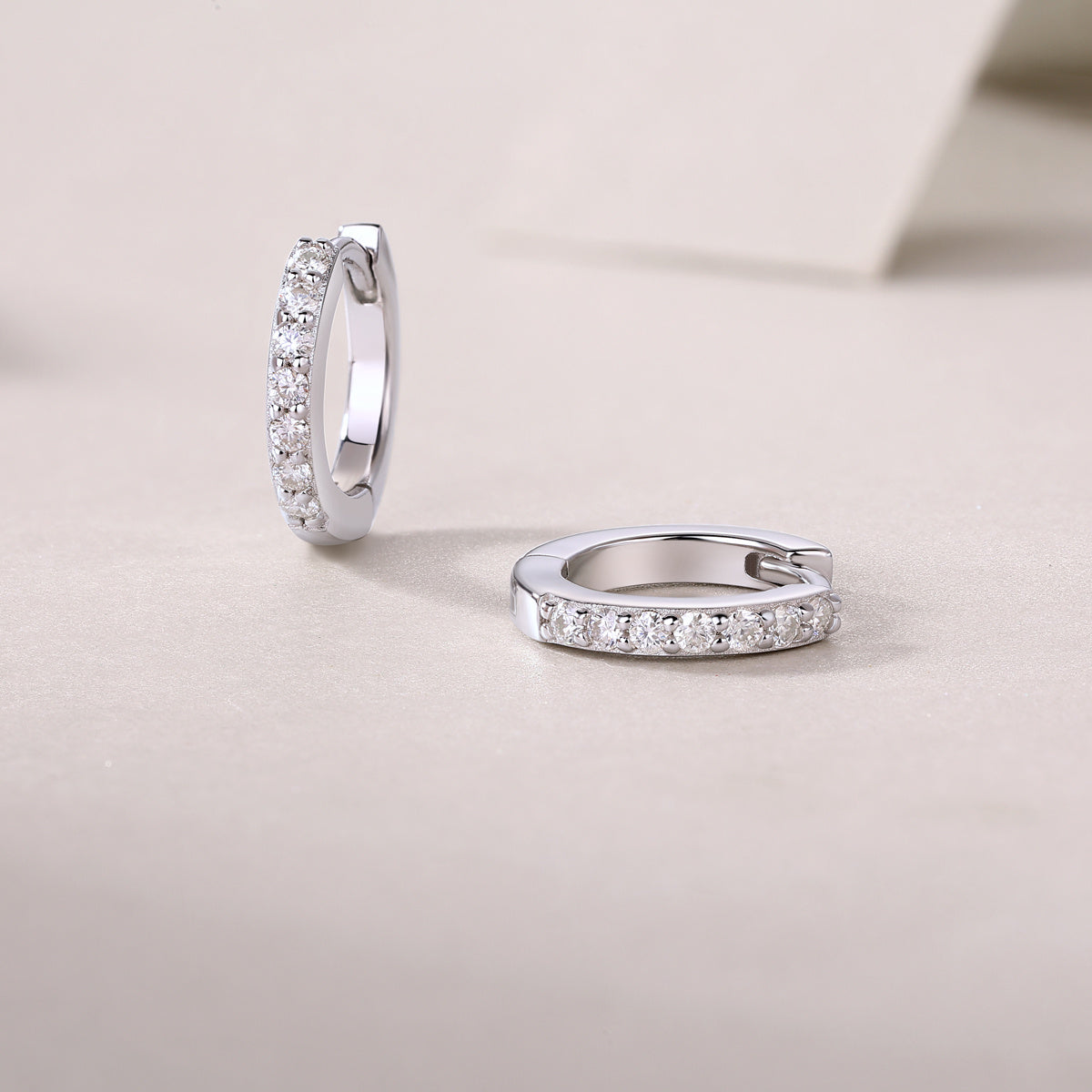 Pair of silver hoop earrings with embedded stones 