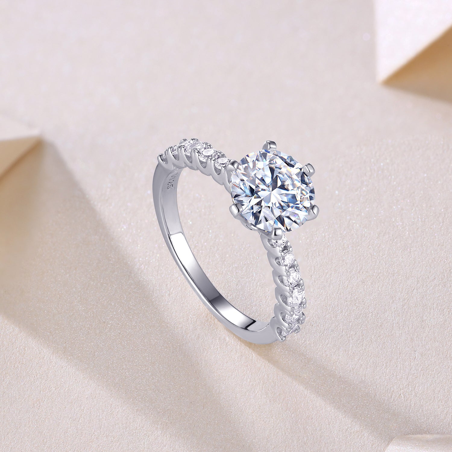 Silver ring with a large diamond and smaller diamonds in the side 