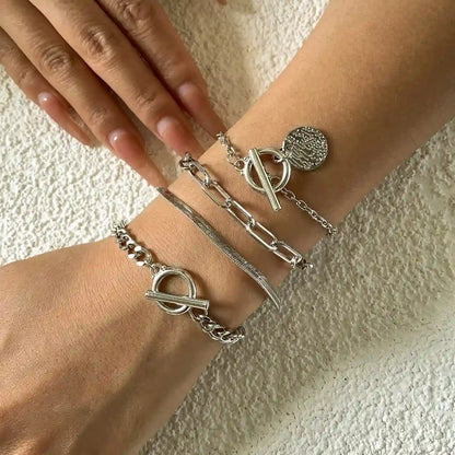 Set of 4 Silver bracelets on a woman wrist 