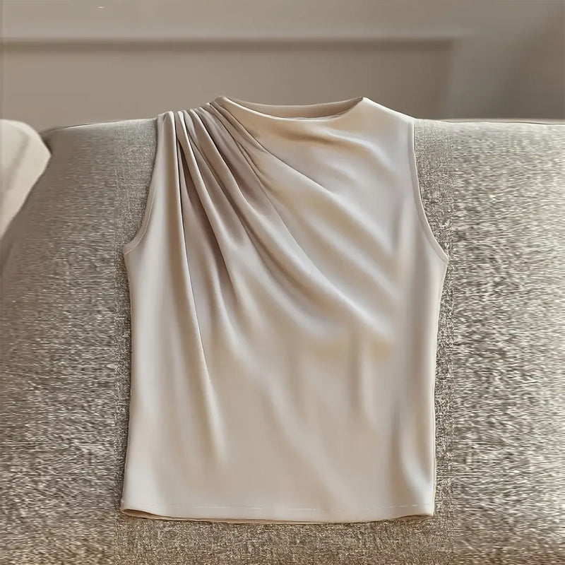 Beige sleeveless top on a textured surface