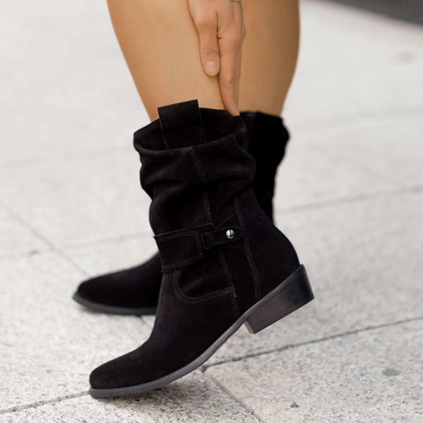 Black suede boots with western-inspired design and zipper

