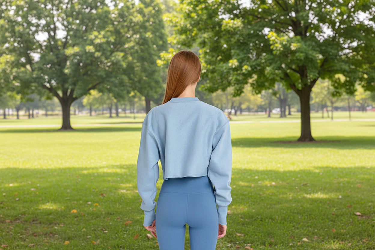 Person wearing a light blue sweatshirt and leggings 