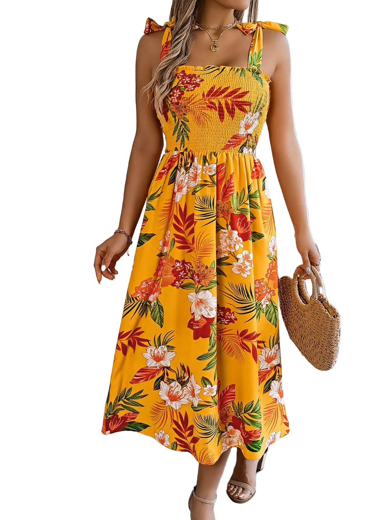 yellow botanical print midi dress styled with straw bag 