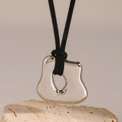 Silver pendant on a black cord 