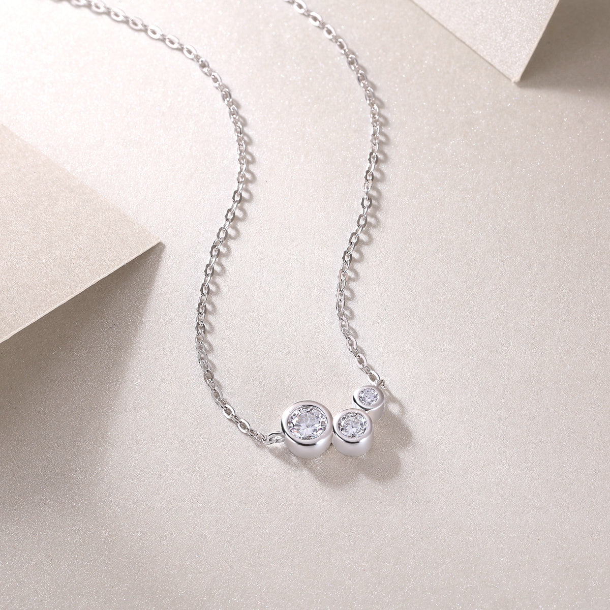 Silver necklace with three round moissanite diamond pendants 