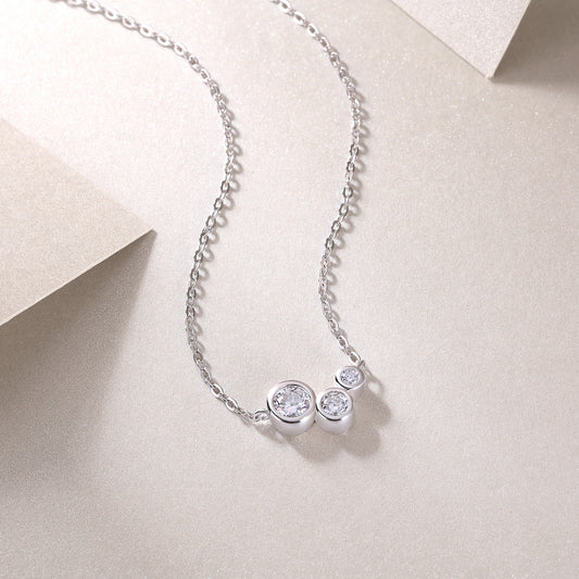 Silver necklace with three round moissanite diamond pendants 
