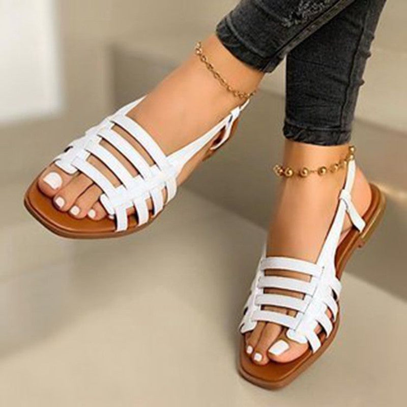 White leather sandals with brown soles
