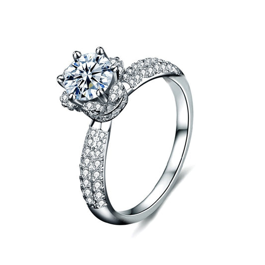 Silver ring with a large central gemstone and smaller stones 