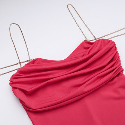 Red dress on a gold hanger against a white background