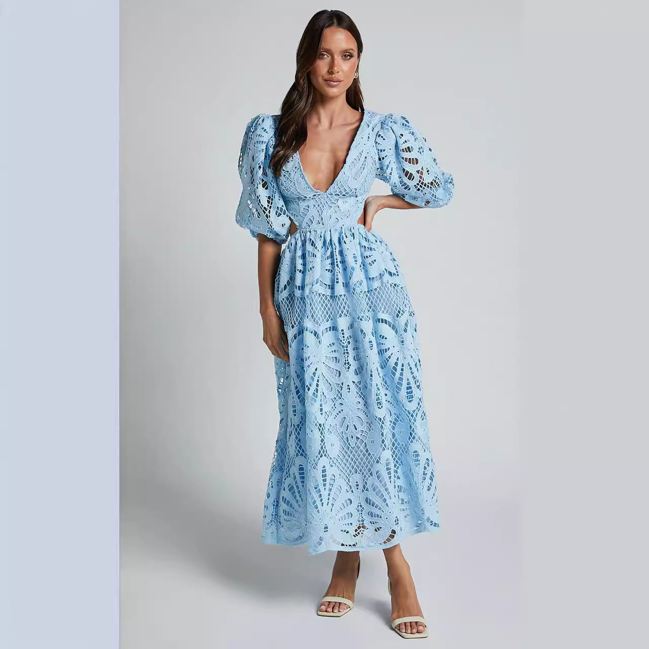 Woman wearing a light blue lace dress with short sleeves 