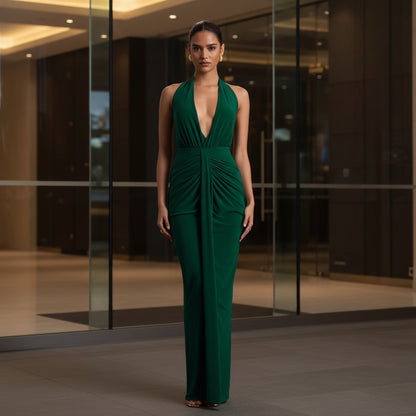 Deep V-neck halter maxi dress in emerald green – front view showing ruched knot waist detail and pleated construction
