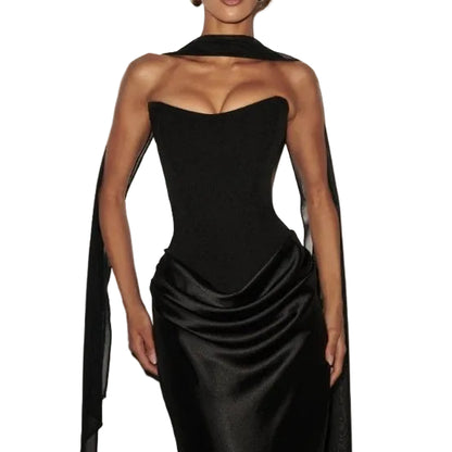 Woman wearing a black one-shoulder gown with a cape 
