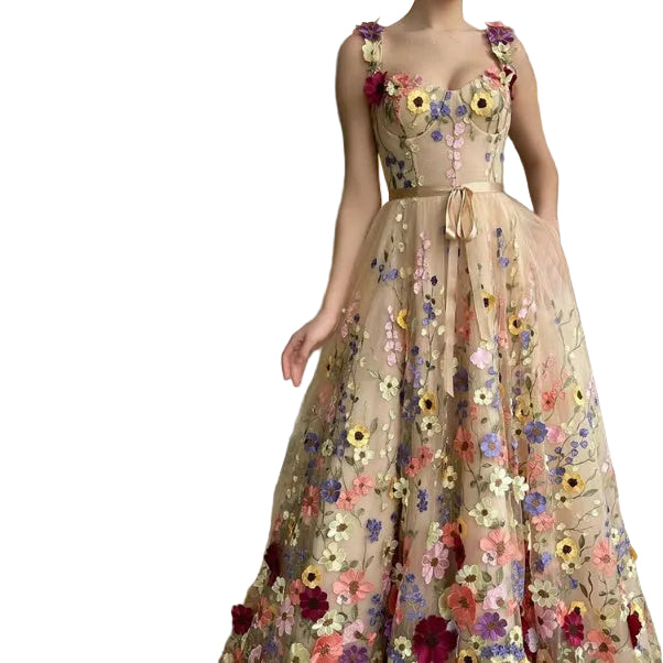 Close-up of champagne 3D floral applique prom dress sweetheart bodice with ribbon waist tie and floral straps
