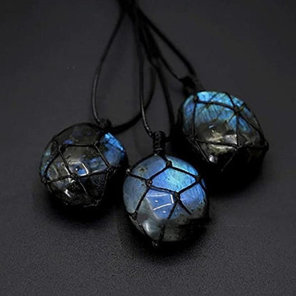 Three glowing Labradorite stones on a dark background