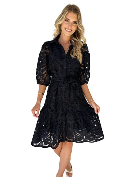 Woman wearing a black lace dress perfecr for cocktail parties