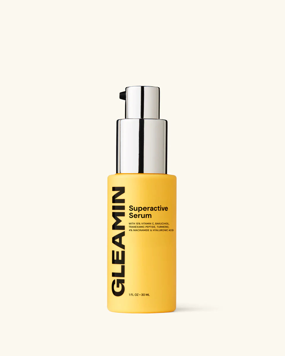 Yellow serum bottle with silver cap on a white background