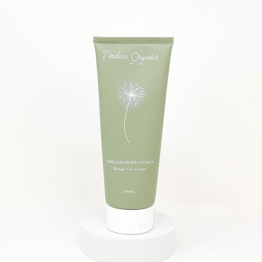 Green tube of body lotion with dandelion design on a white background