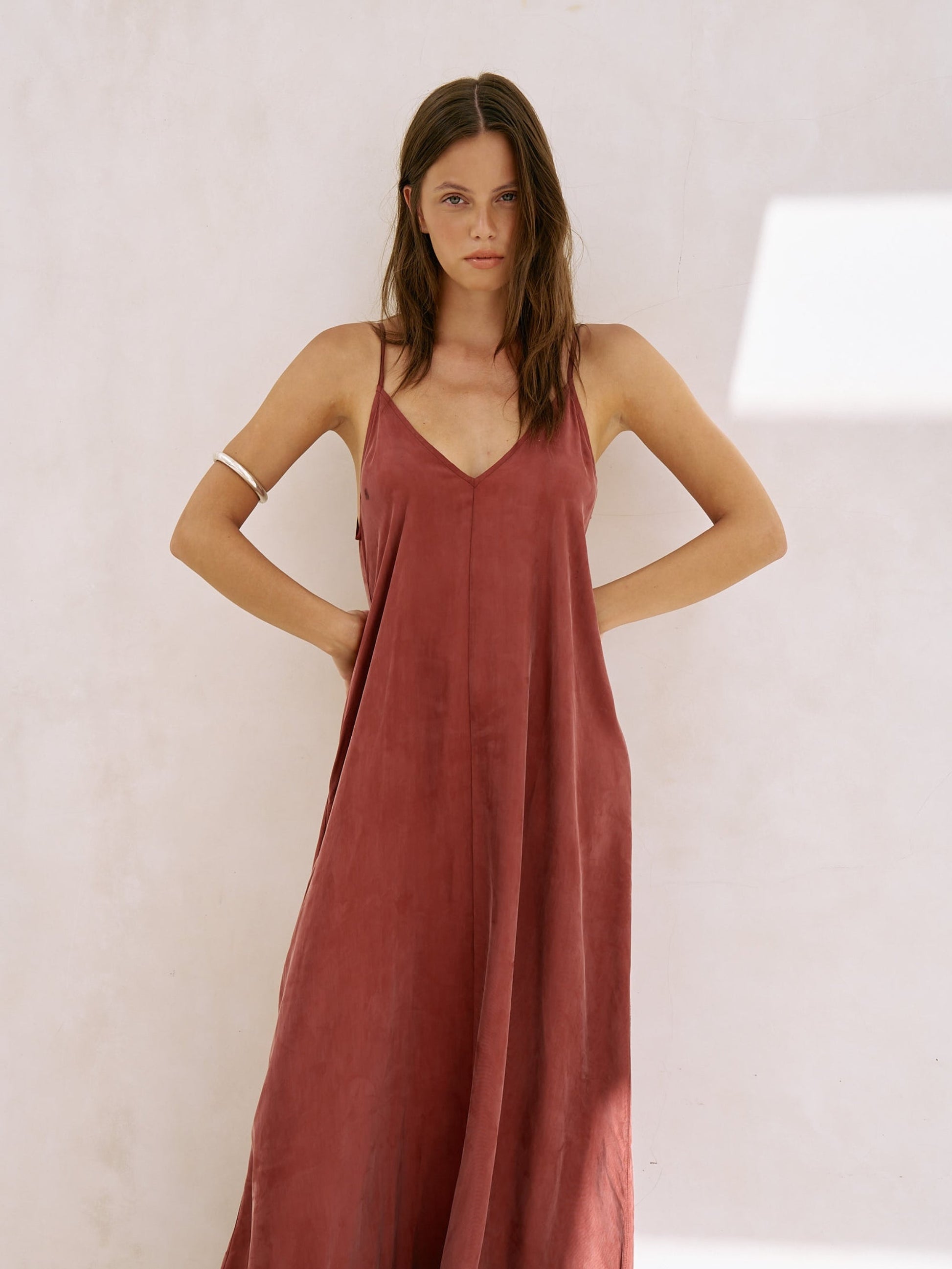Woman wearing a rust-colored strapless dress 