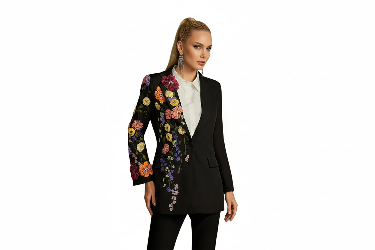 Woman wearing a black blazer with colorful floral embroidery 