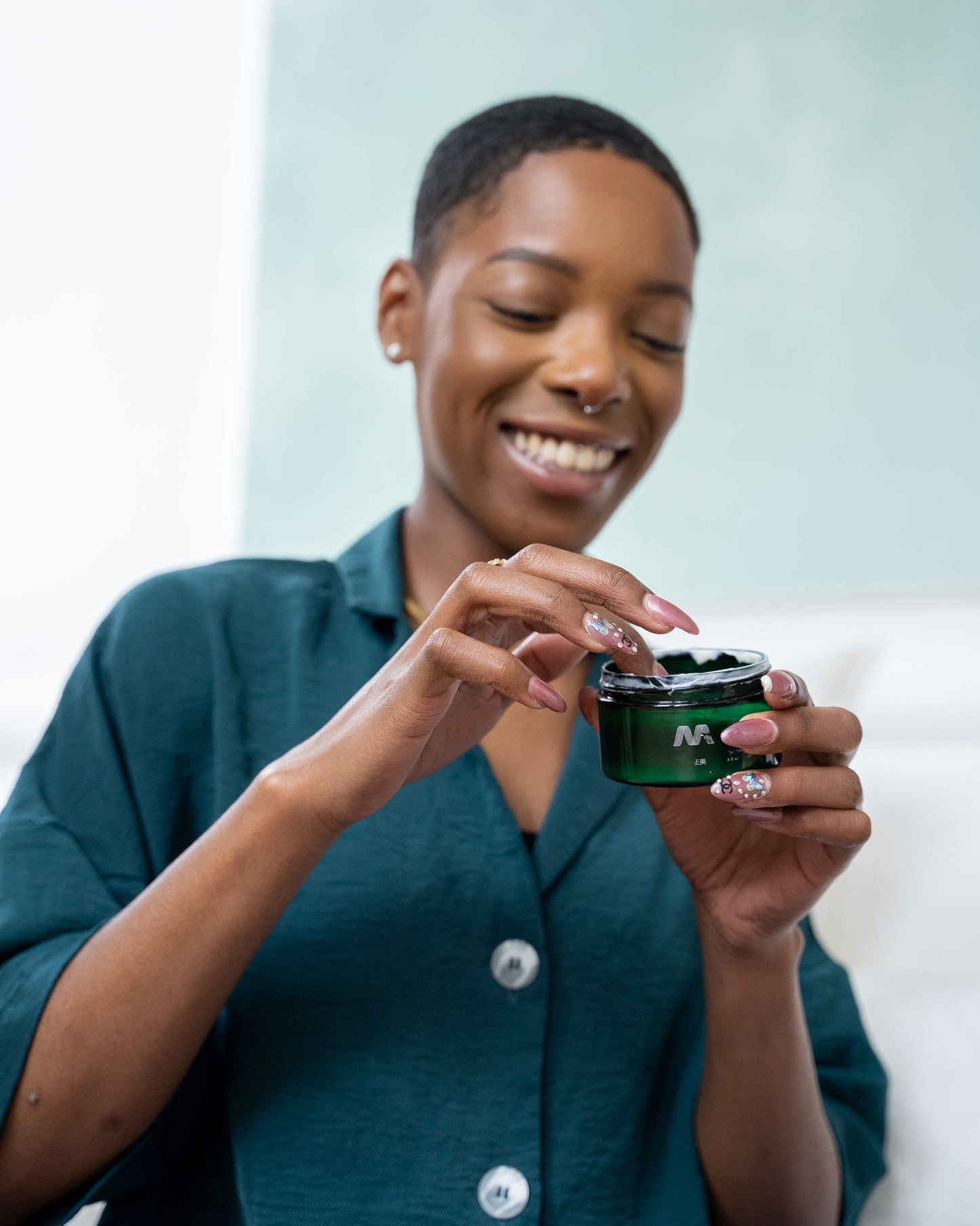 Woman holding a green  Masami product container 