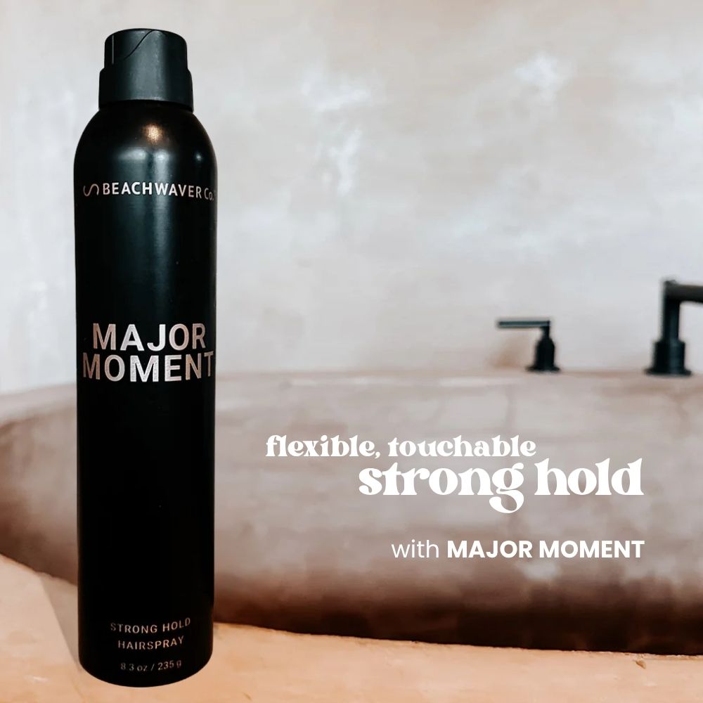 Black hair spray can labeled 'Major Moment"