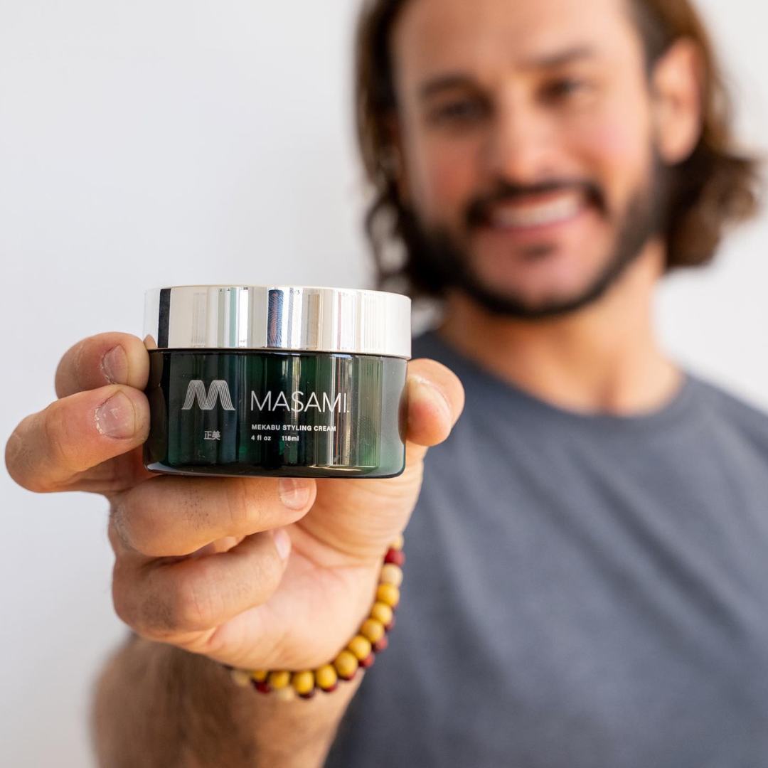 Person holding a jar of Masami  best hair product 