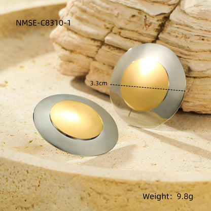 circular earrings  with gold centers and silver outer rims 
