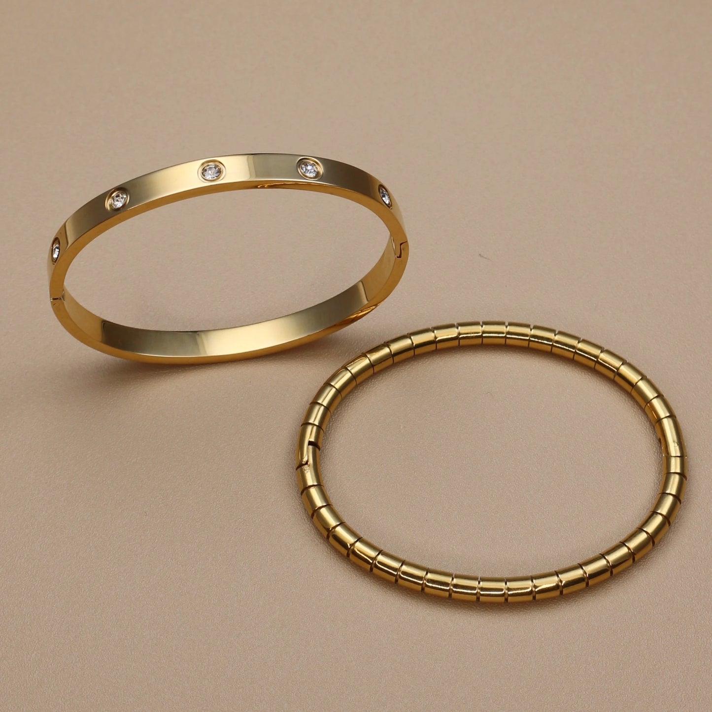 High-polished gold bangle bracelet with bezel-set zircon stones – women's luxury jewelry
