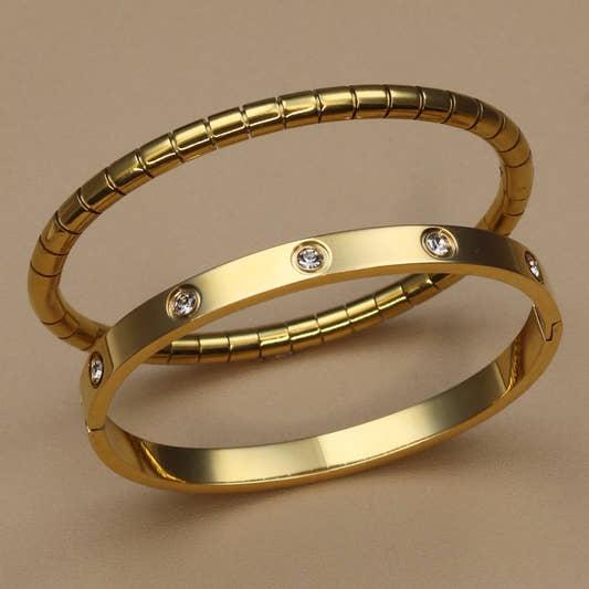Gold stainless steel bangle set with zircon stones – ribbed and smooth bangles stacked together
