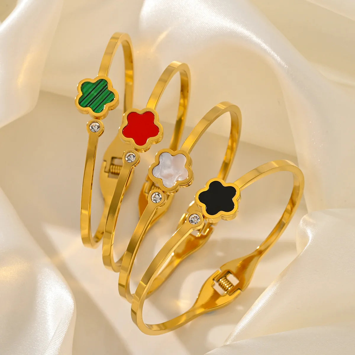 Set of gold bangles with colorful flower-shaped 
