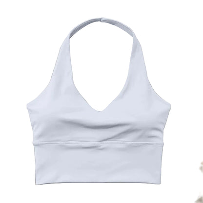 White sports bra on a light wooden surface with floral decorations