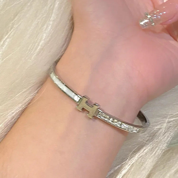 H silver bangle with studs 