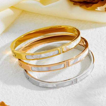 Gold hinged bangle with mother of pearl shell inlay panels and zirconia accent bar – stainless steel bracelet
