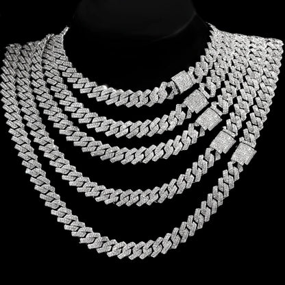 Multiple diamond-studded cuban necklaces on a black background 
