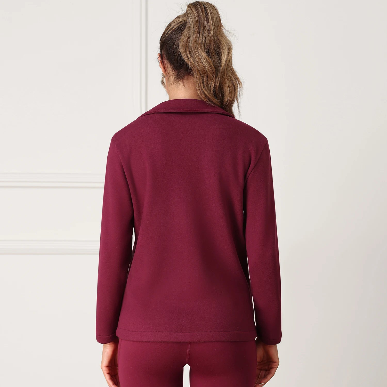 Person wearing a maroon tracksuit 