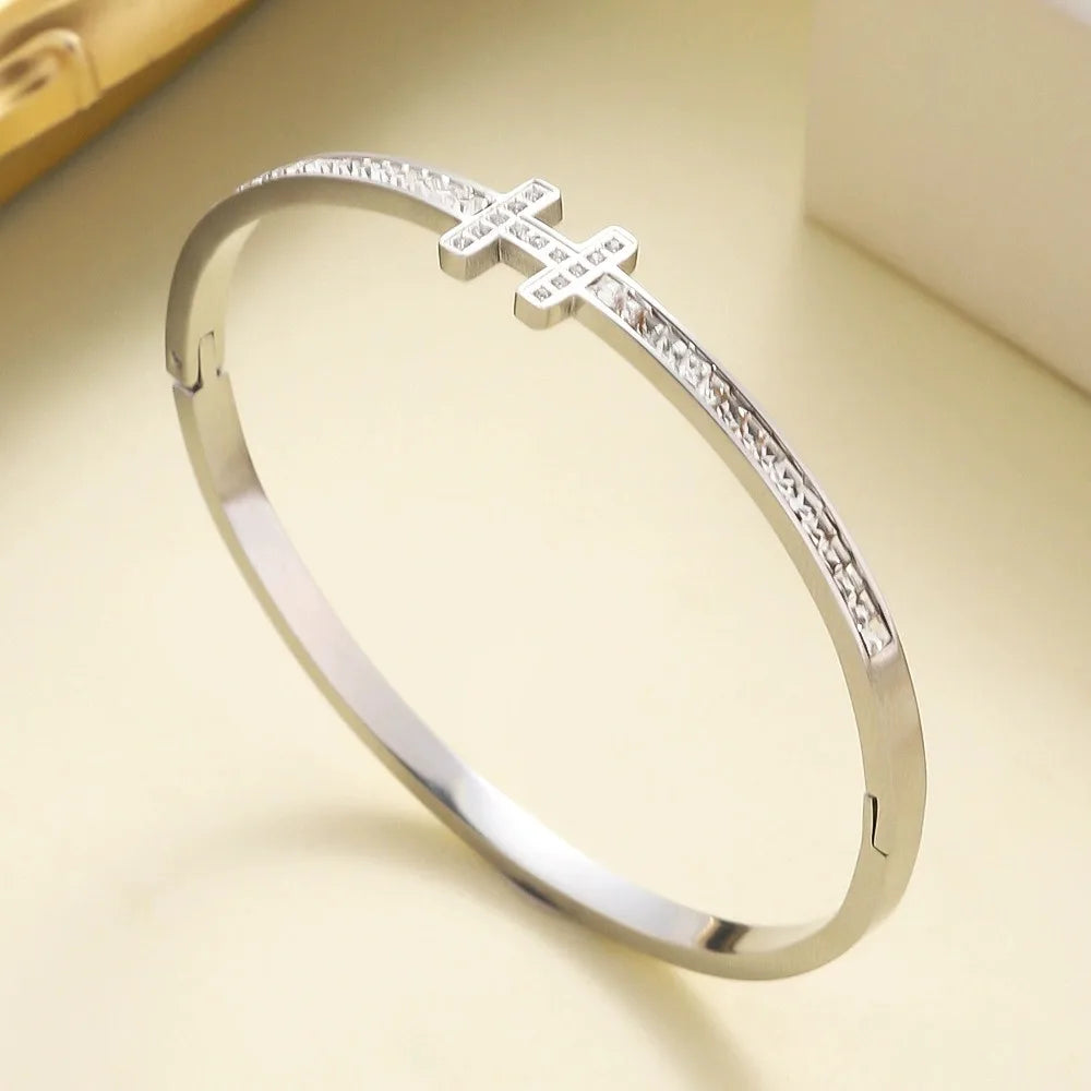 Polished stainless steel bangle with H-shaped centerpiece and pavé zirconia stone band – luxury-inspired bracelet
