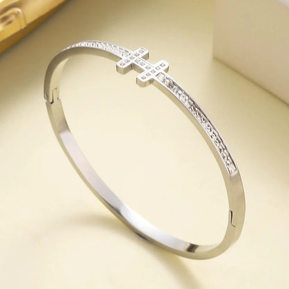 Polished stainless steel bangle with H-shaped centerpiece and pavé zirconia stone band – luxury-inspired bracelet

