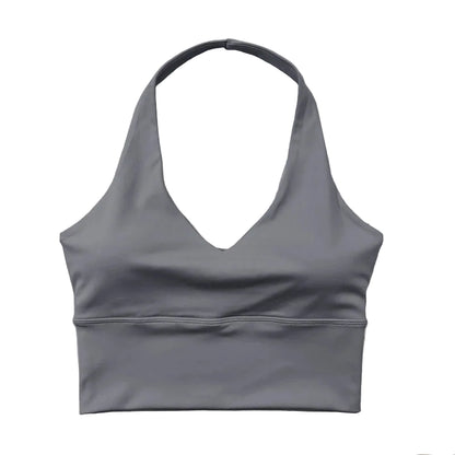 Gray sports bra on a light wooden with floral decorations