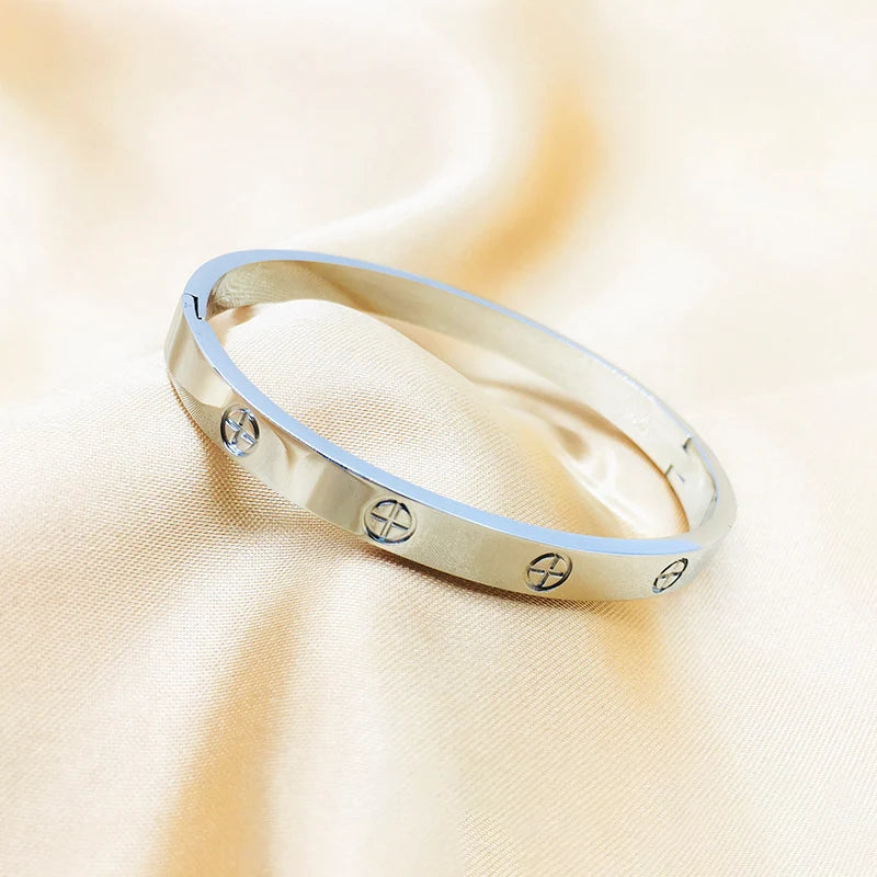 silver cartier imitation bracelet with engraved symbols 