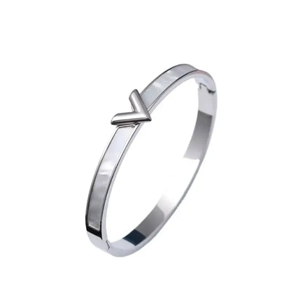 Silver tone V bangle bracelet close-up showing shell inlay detail – luxury stainless steel jewelry

