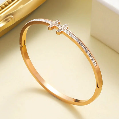 Hinged stainless steel bangle with H-design charm and square-cut zirconia stones along the band
