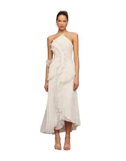 Woman wearing a white one-shoulder dress with a ruffled design 