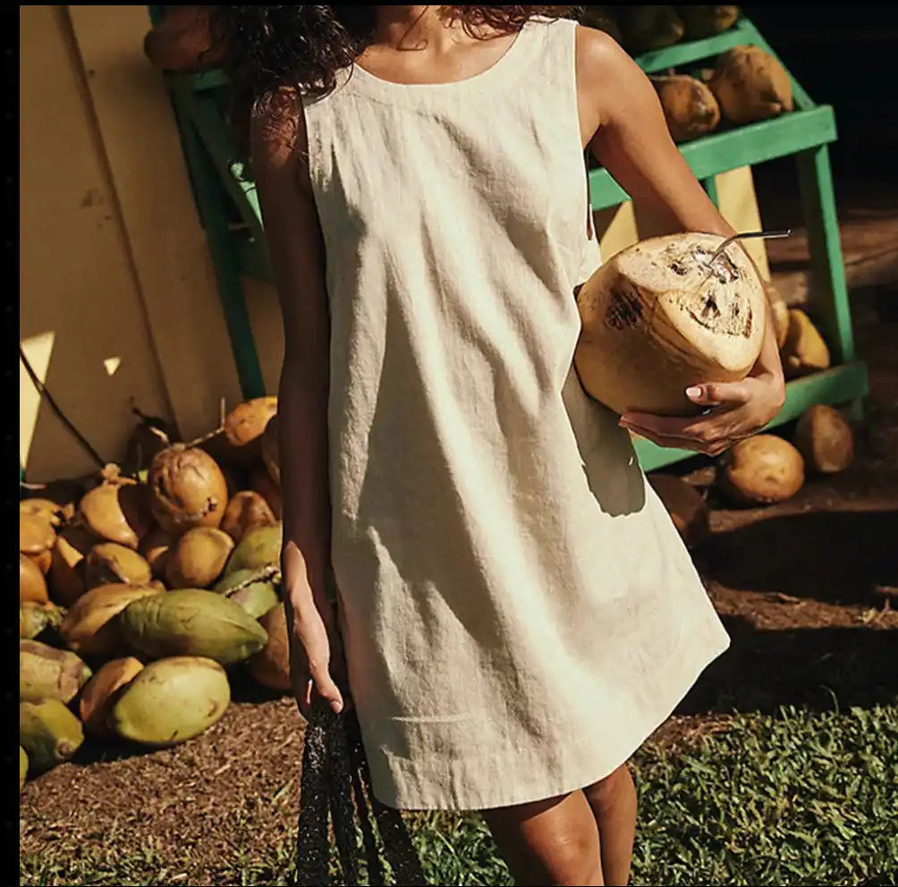 woman wearing a mini linen beige dress at the farmer market 