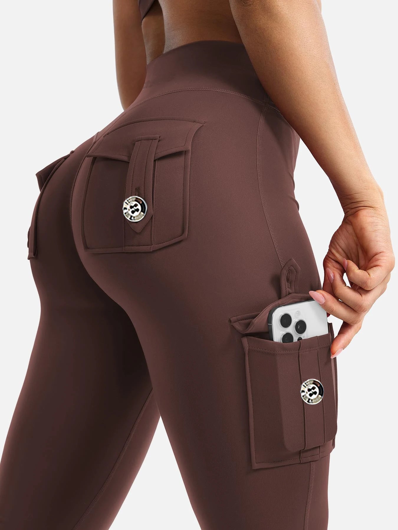 Side phone pocket on high waist cargo leggings holding smartphone
