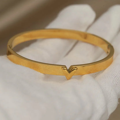 Gold rigid bangle with raised V-shaped accent – rust-proof stainless steel bracelet 
