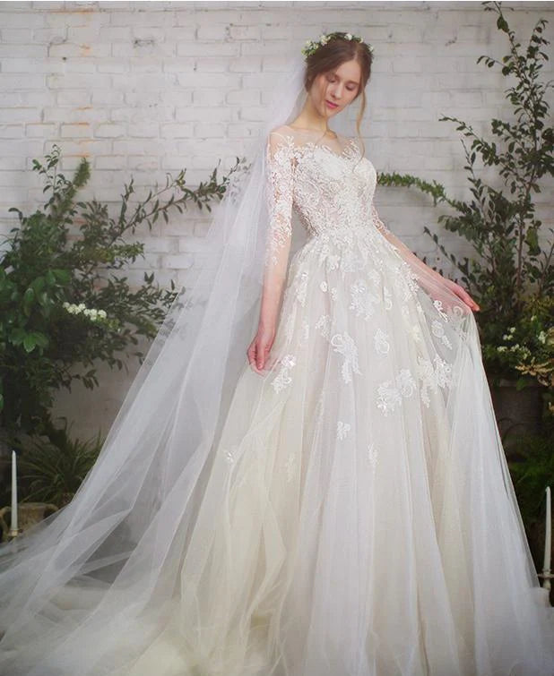 Front view of ivory lace wedding dress with natural waist and voluminous tulle skirt

