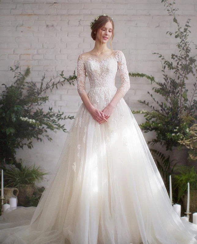 Back view of ivory wedding gown with lace-up back closure and elegant court train

