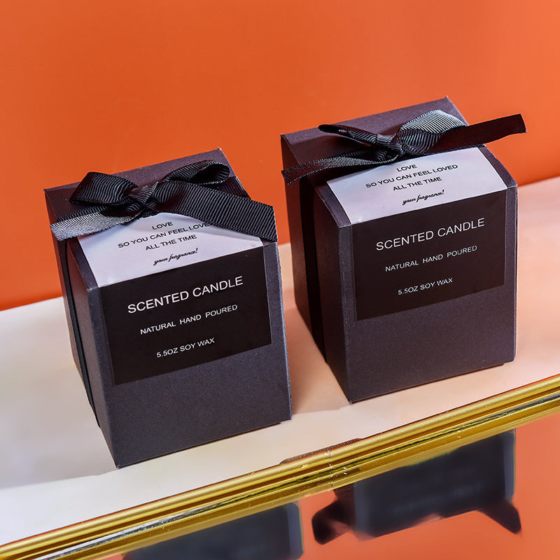 Two scented candles in black boxes with ribbons  perfect gifts for the holidays 